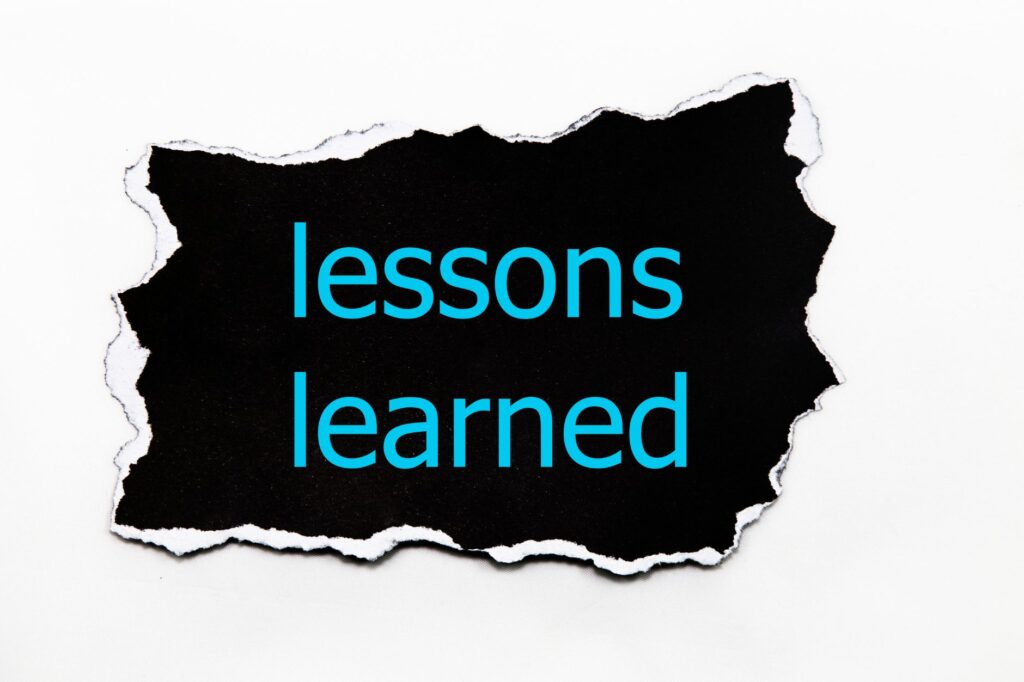 Ripped black paper with the words "lessons learned" in blue text on a white background, highlighting insights for a robust Cyber Resilience Strategy.