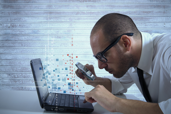 Man looking into a laptop closely