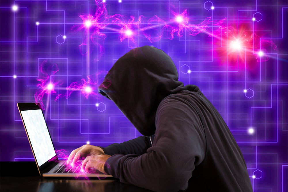 A hacker using a laptop.